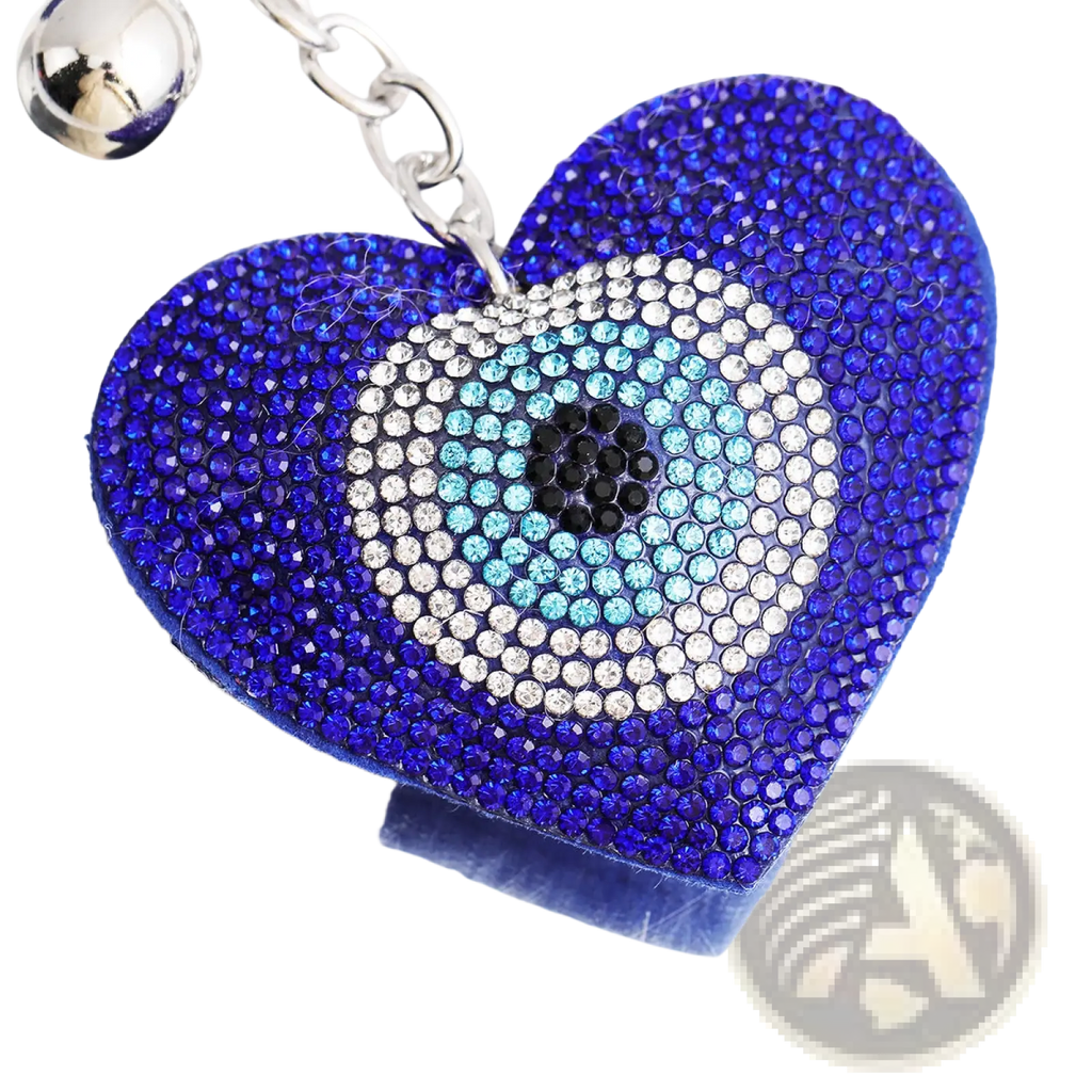 A heart-shaped evil eye keychain with blue and silver rhinestones and a leather tassel detail