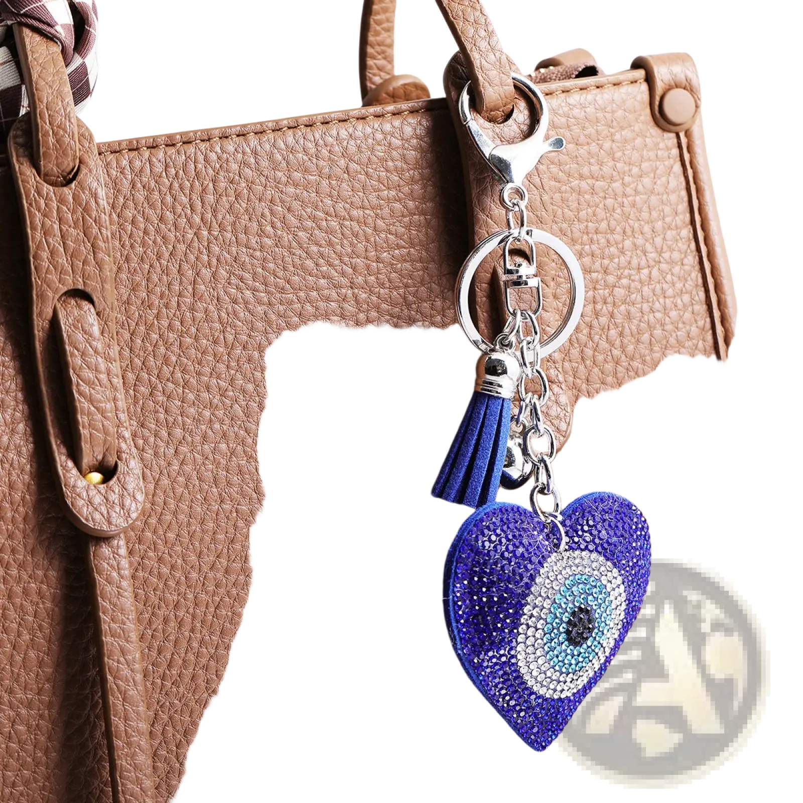 A blue leather heart keychain with rhinestones tassel and an intricate evil eye design