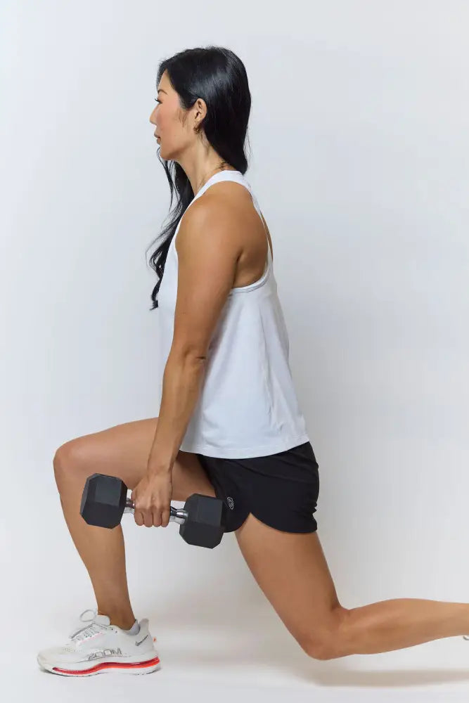 Black hexagonal dumbbell with silver metal handle shown alongside excel women’s black camouflage athletic workout shorts