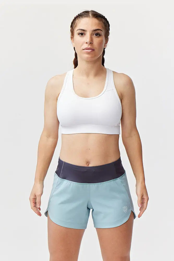 Excel women’s athletic workout shorts in light blue with dark navy waistband and small logo on the lower right leg