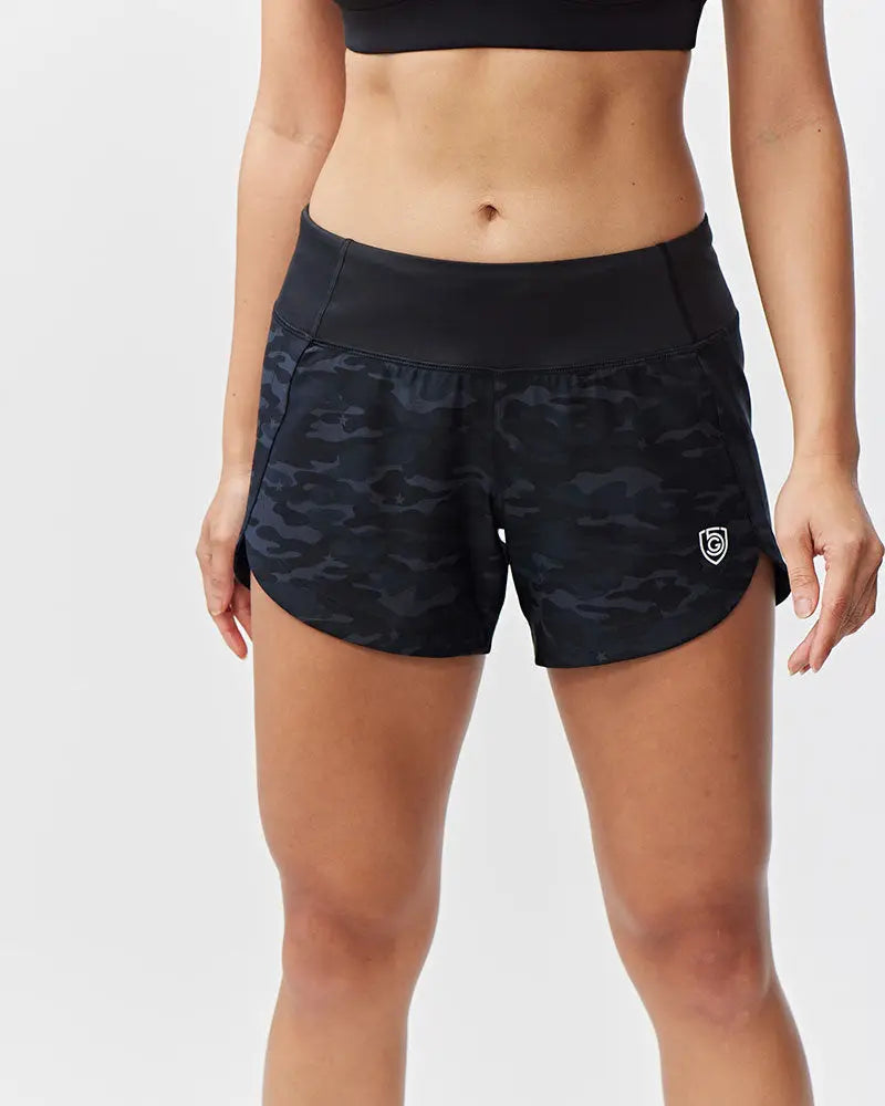 Excel women’s black camouflage athletic workout shorts with high-waisted elastic band and white logo on lower right leg
