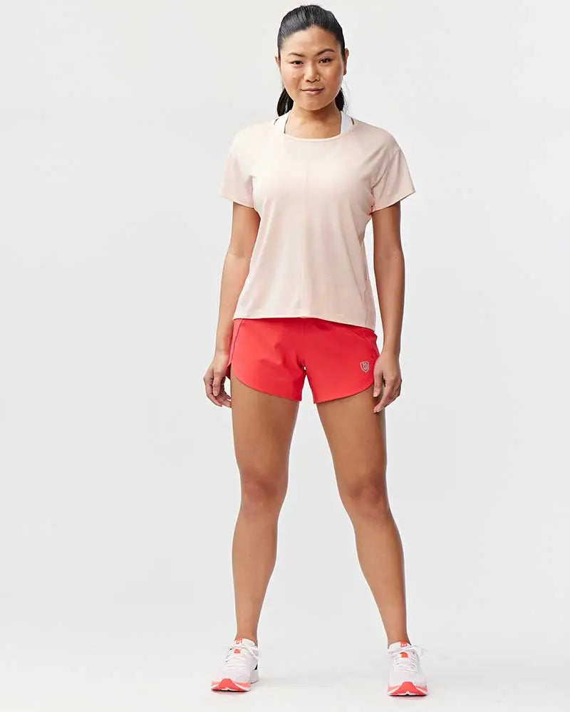 A woman wearing bright red Excel women’s black camouflage athletic workout shorts with a small logo on the left leg