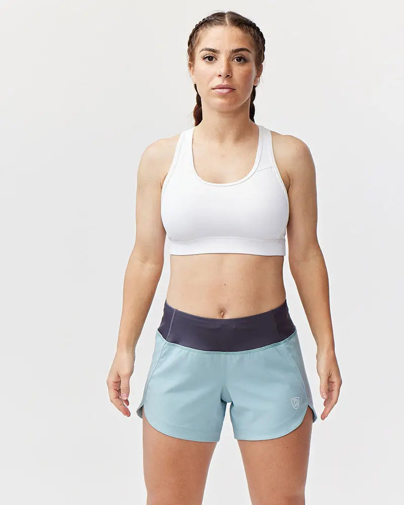 Excel women’s athletic workout shorts in light blue with dark navy waistband and logo on lower right leg