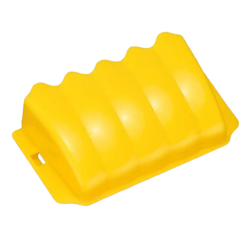 Bright yellow plastic wheel chock with wavy ridged top and handle cutout for external rabbit hay food rack use