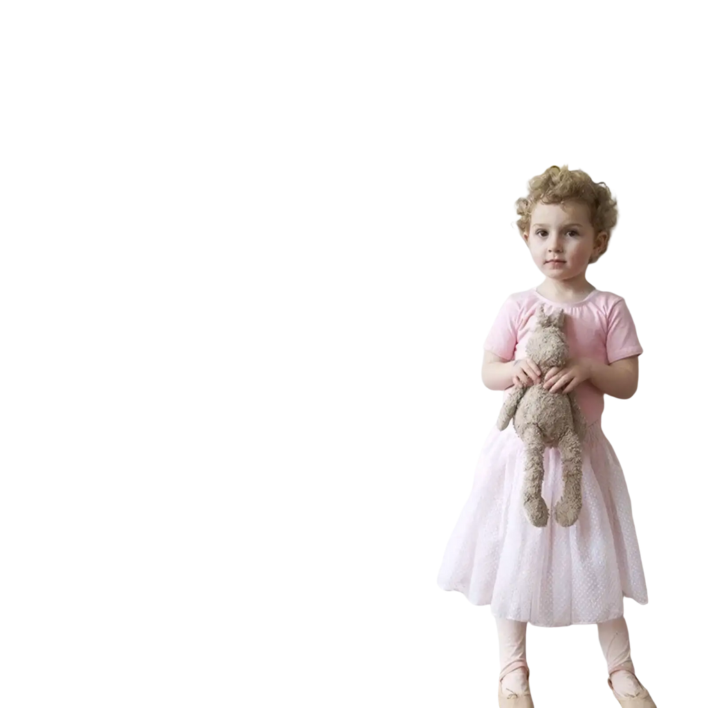 A young girl beside black eyelash wall stickers in a pink dress showcasing Nordic girl bedroom decor