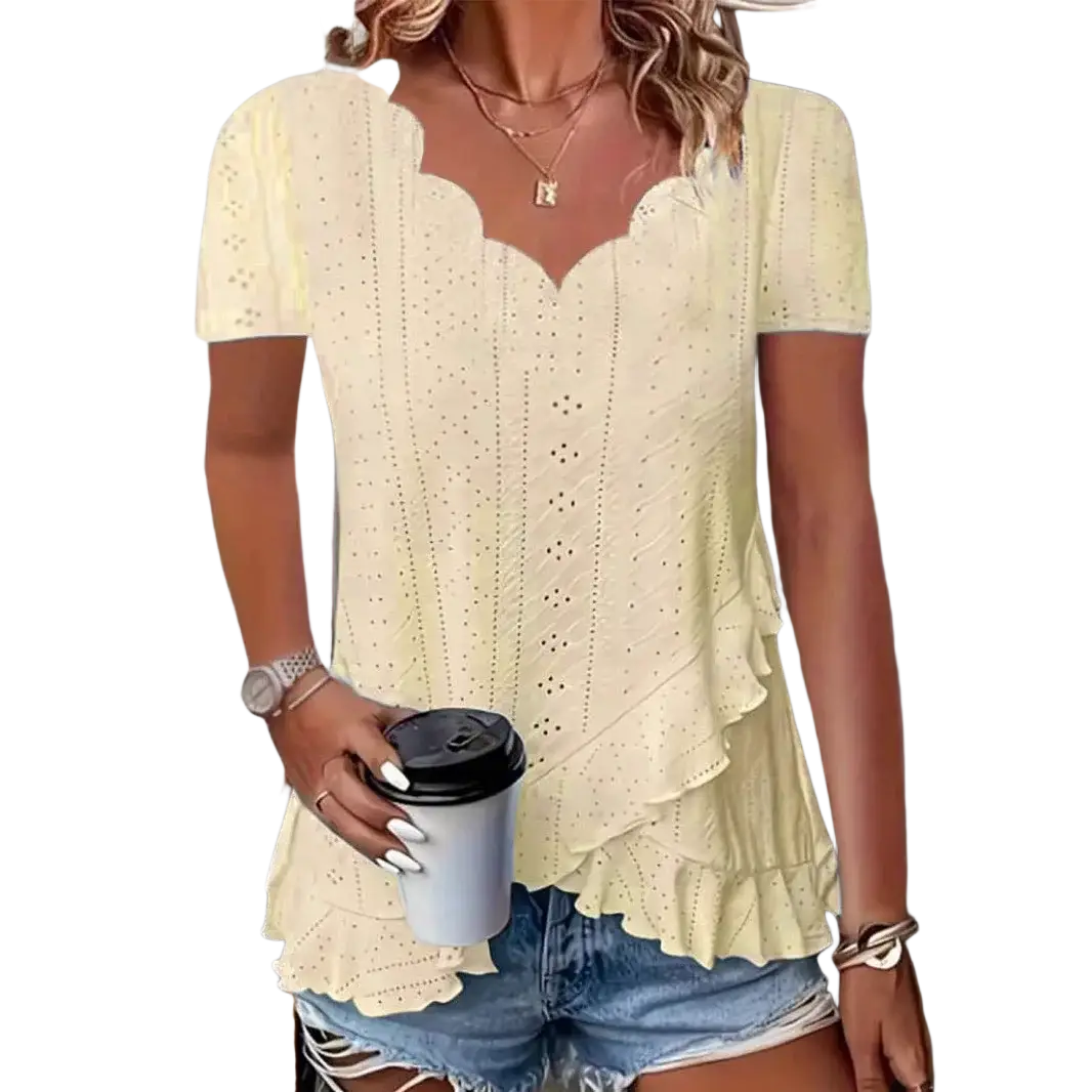 A pale yellow eyelet ruffle v-neck blouse with short sleeves and scalloped neckline featuring delicate hem detailing