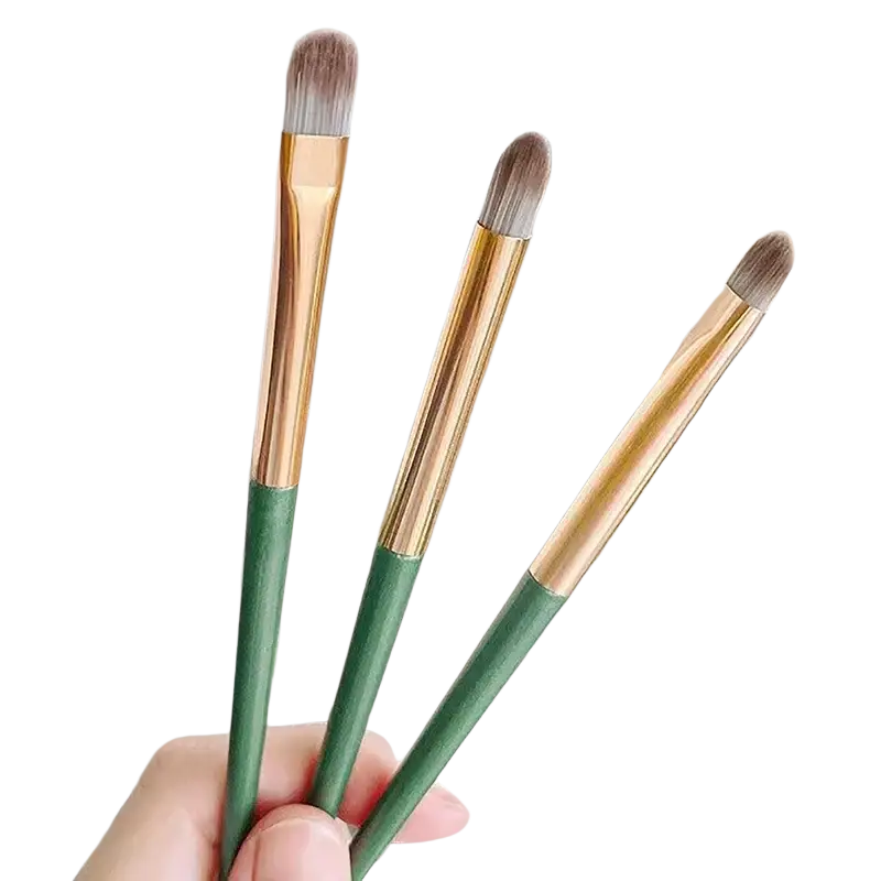 Professional eyeshadow brush set with three soft makeup brushes featuring green handles and gold ferrules for precise application