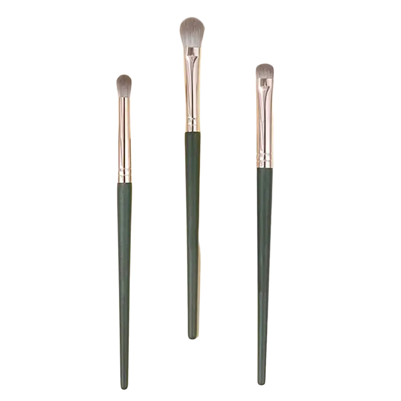 Three elegant eyeshadow brushes with dark green handles silver ferrules and soft gray bristles for professional makeup use