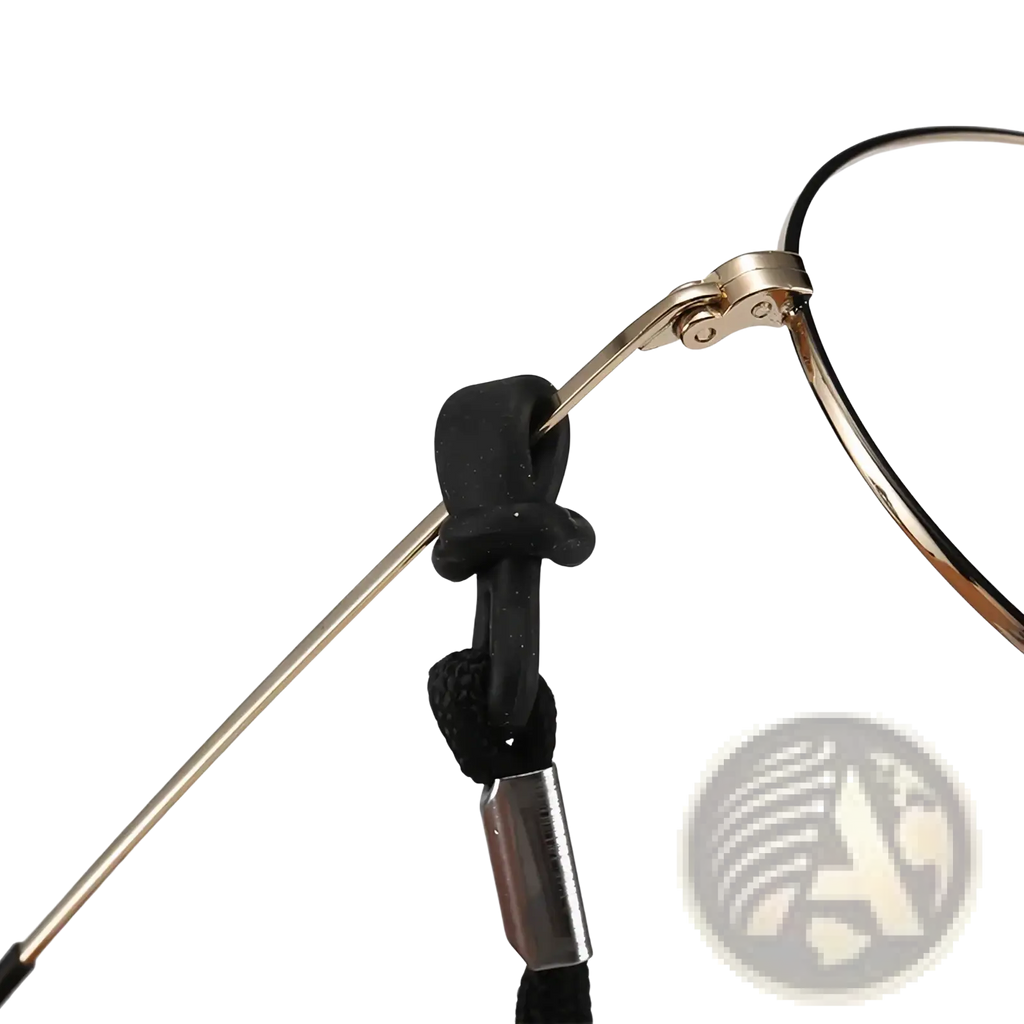 Black braided non-slip sports eyewear strap with metallic clasp attached to gold-toned eyeglass frames