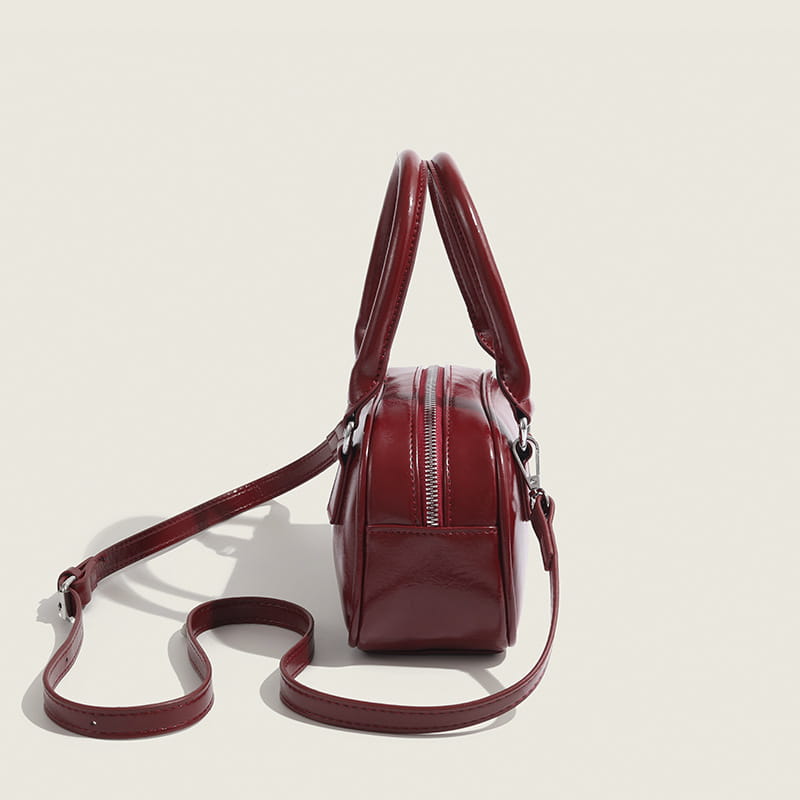 A glossy burgundy retro Pu leather small square handbag 20cm with rounded handles and a detachable strap.