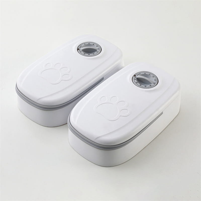 White plastic automatic pet feeder gravity waterer and food dispenser with gray paw print design and circular timer on top.