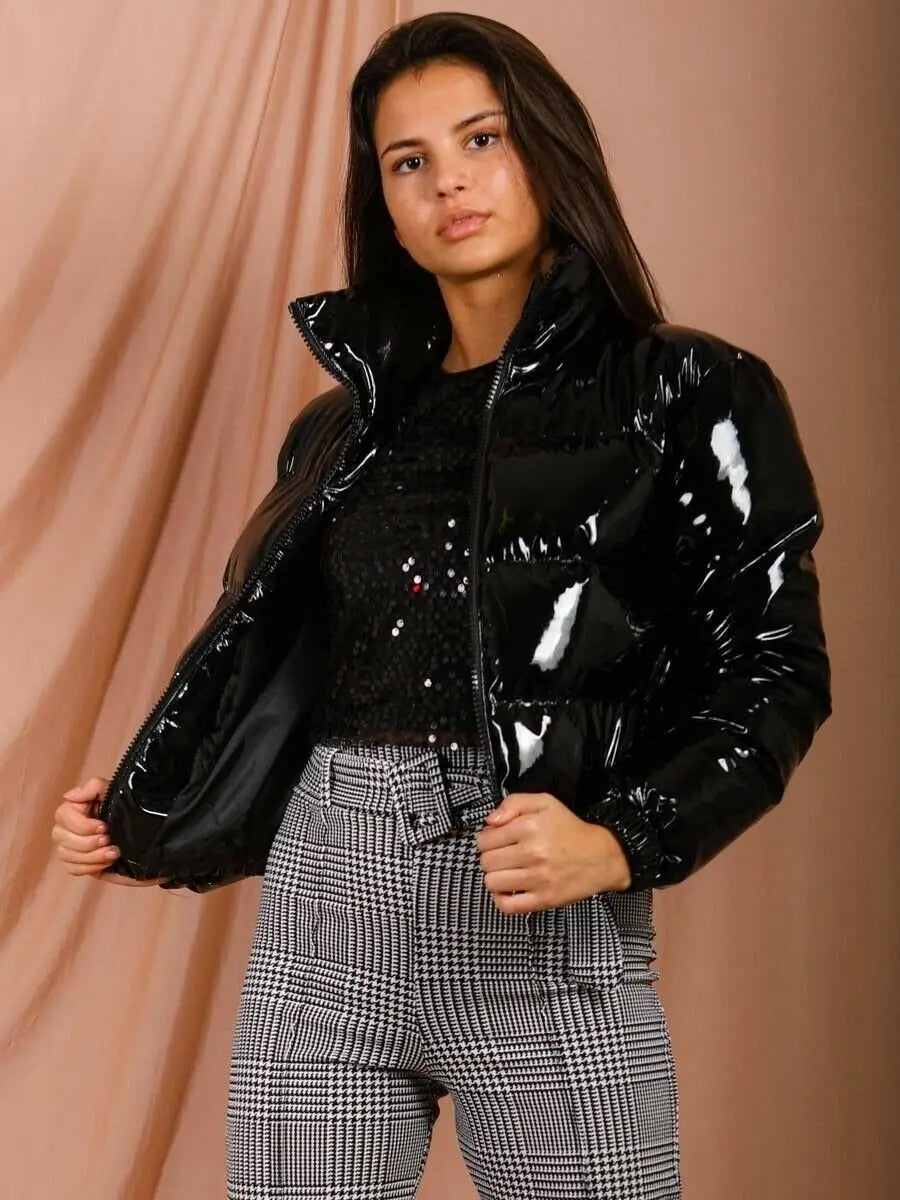 Black glossy puffer jacket short cotton padded for women with a shiny patent-like finish and quilted design for warmth.