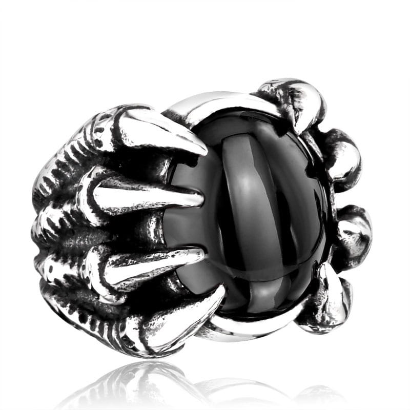 A menacing silver titanium steel claw ring featuring a glossy black onyx gemstone at its center.