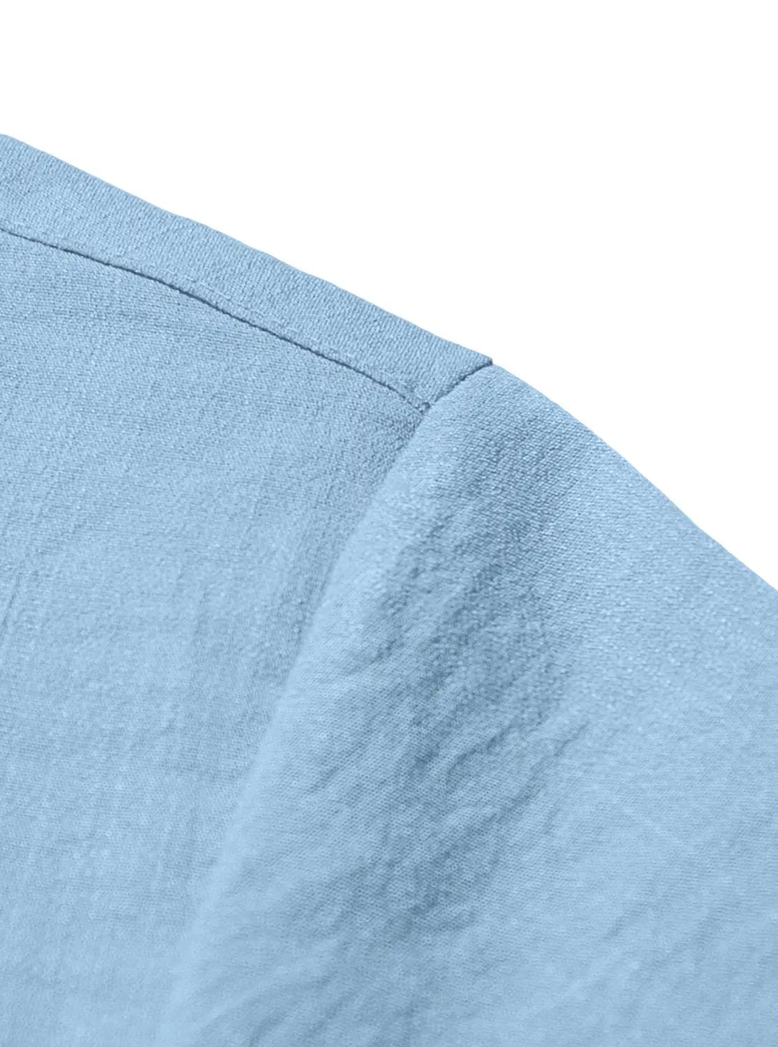 Light blue men’s textured bamboo linen short sleeve button down shirt with soft slightly textured cotton fabric and neatly stitched shoulder seam.