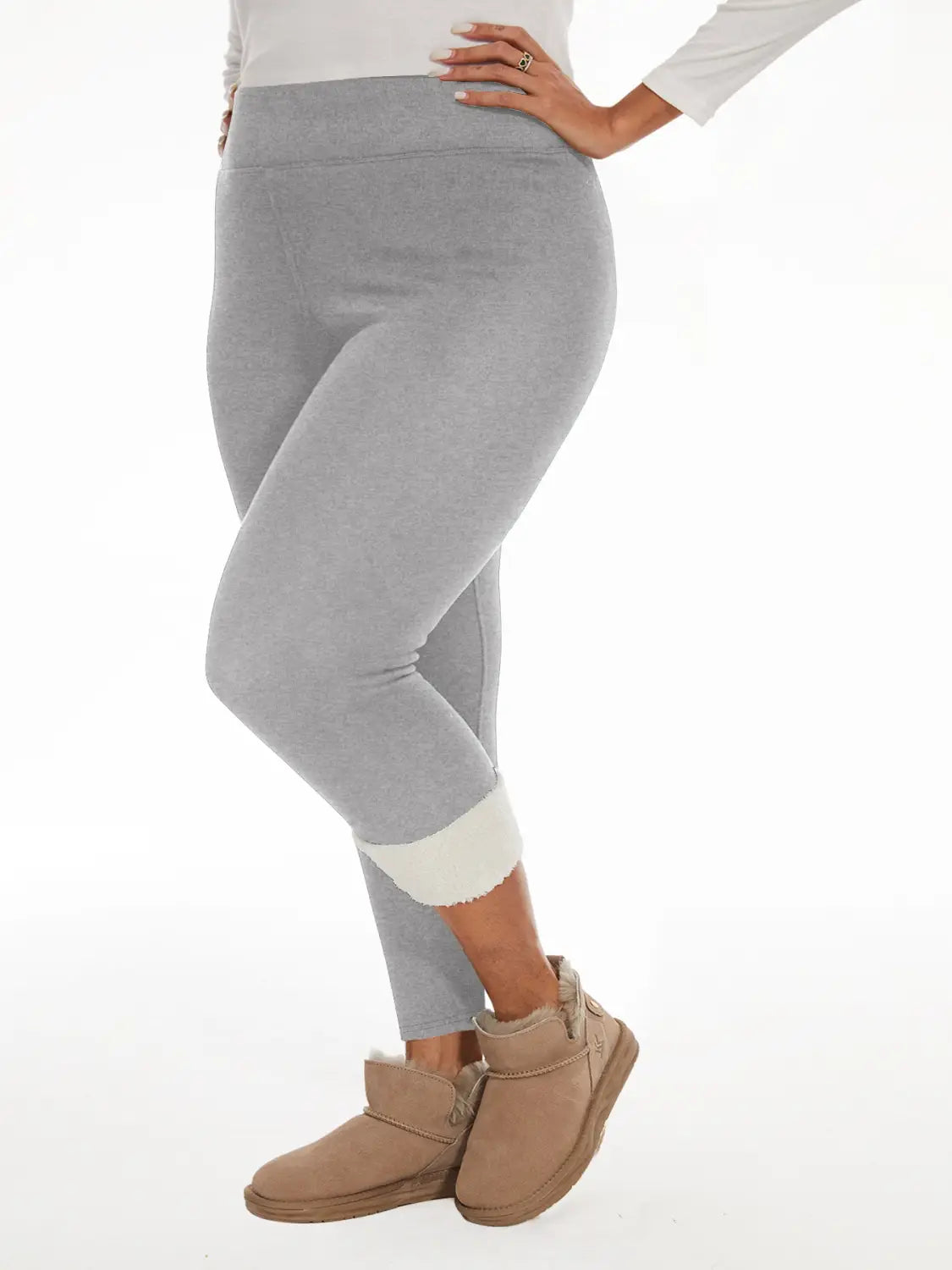 Gray fleece lined high waisted winter leggings with rolled cuffs and contrasting white inner lining.