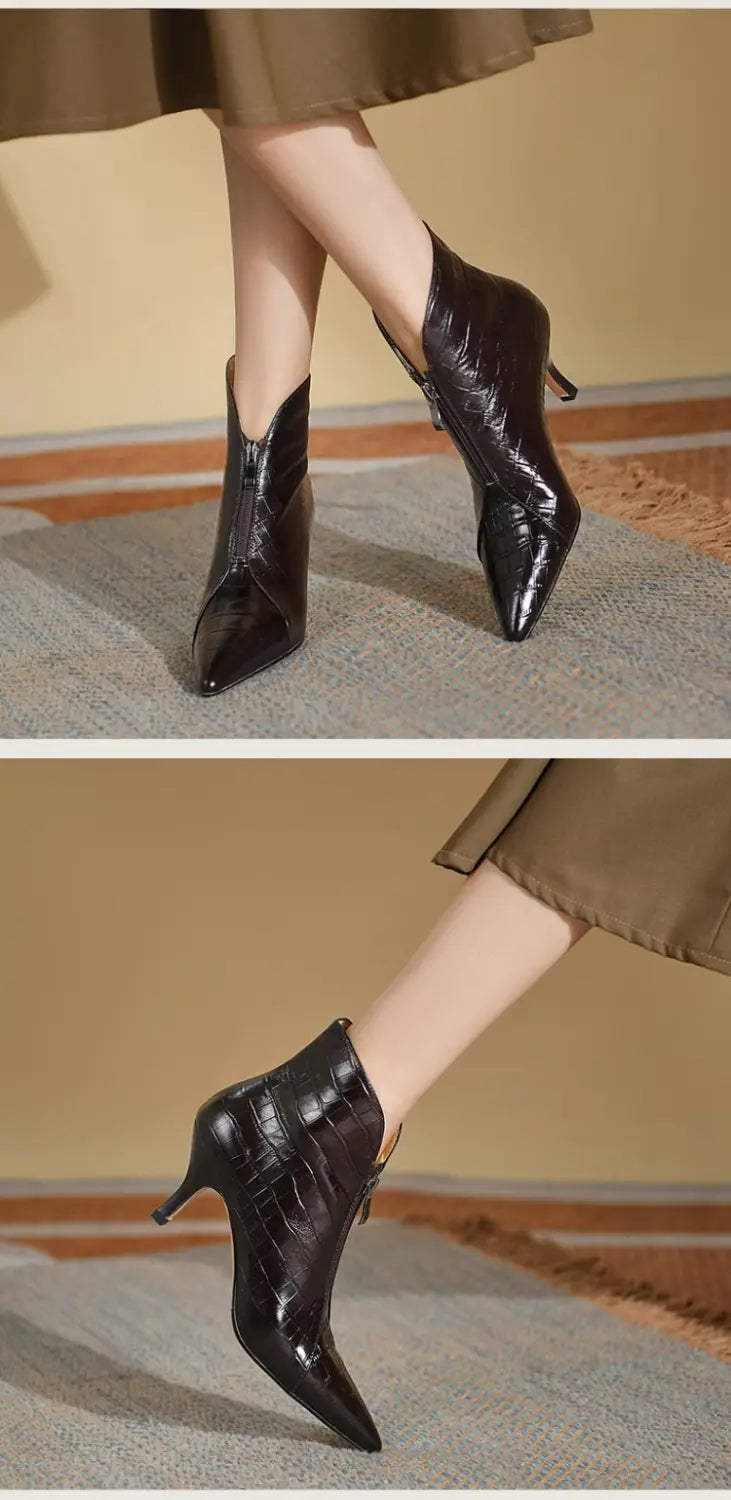 black croc embossed leather stiletto ankle boots with a pointed toe and slim heel shown from the back side