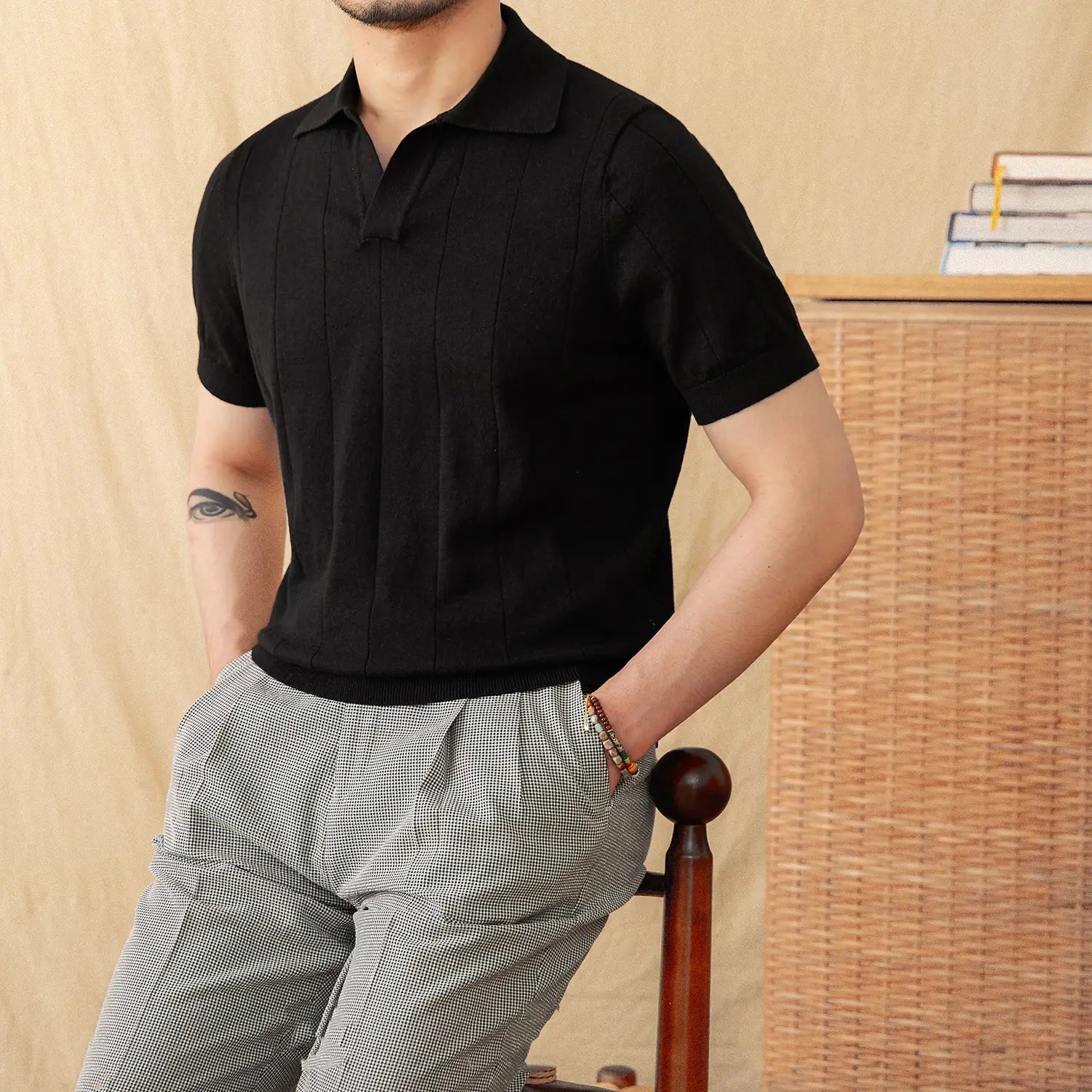 Black men knit stripe polo shirt with ribbed collar and vertical pleats on the front in short sleeve design.