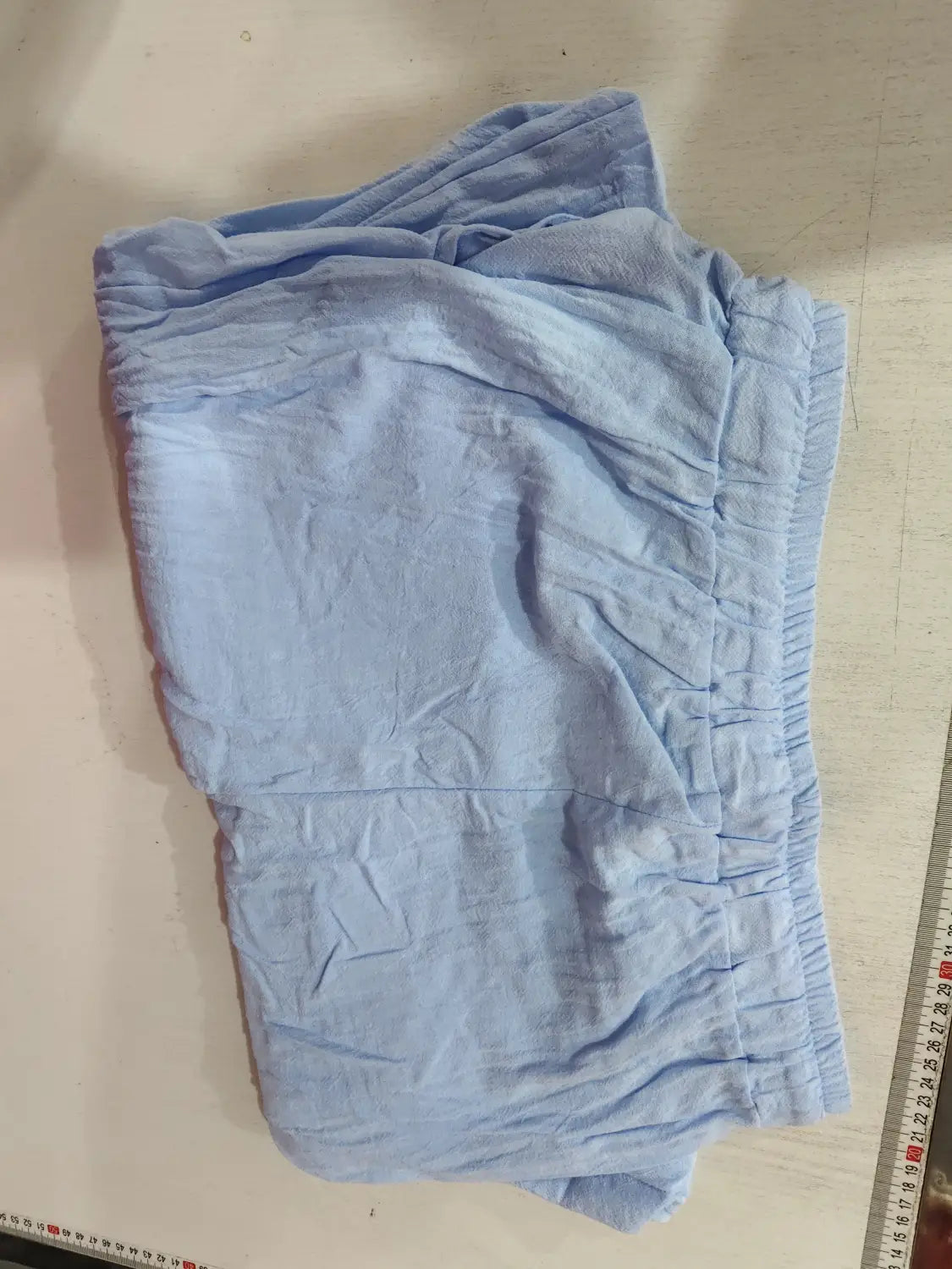Light blue soft-textured linen joggers with an elastic waistband designed for casual summer wear.