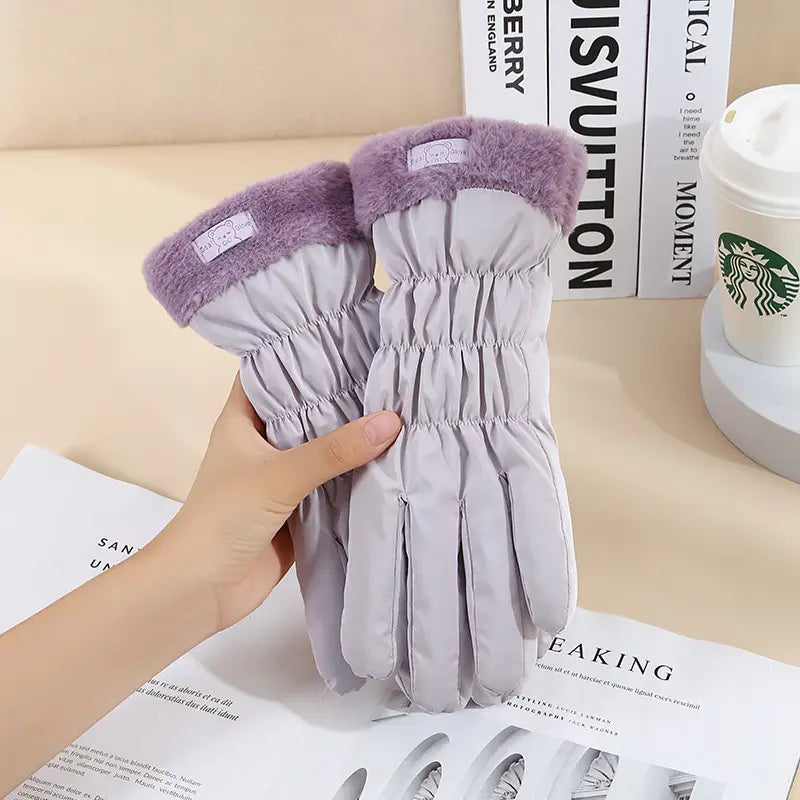 Light gray women touch screen winter fleece gloves with plush purple fleece cuffs and a soft quilted design.