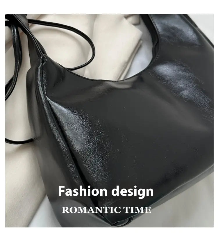 Black glossy faux leather ruched shoulder bag with a sleek minimalist design patent leather handbag.