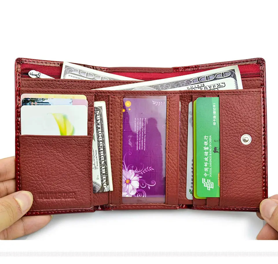 Retro crocodile pattern leather trifold wallet in red with textured surface and visible stitching holding cash and cards including a green bank card.