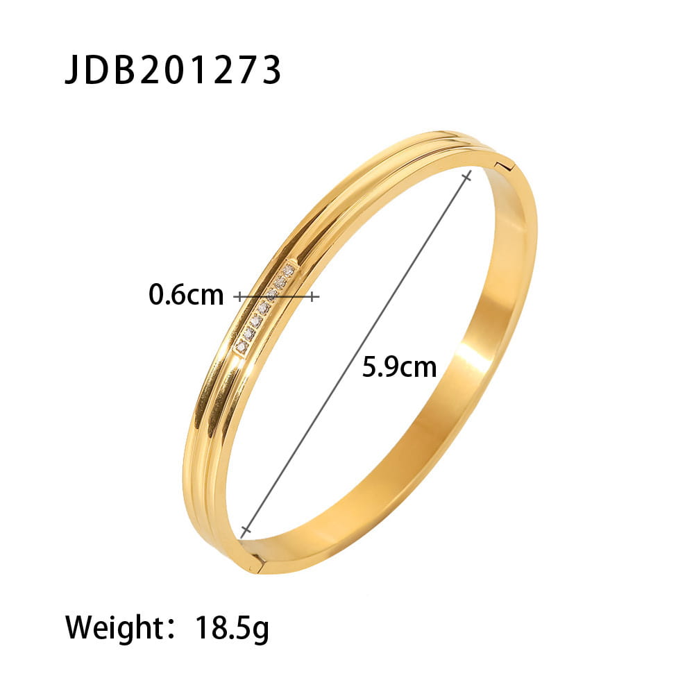 Gold plated stainless steel bangle bracelet with a gold-toned sleek double-ridged design and a row of small clear zirconia gemstones along the inner edge.