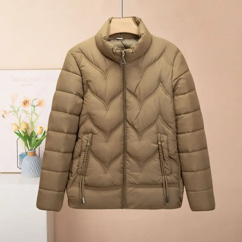 Beige quilted puffer jacket for women made of down with a high collar and chevron stitching pattern designed for winter use.