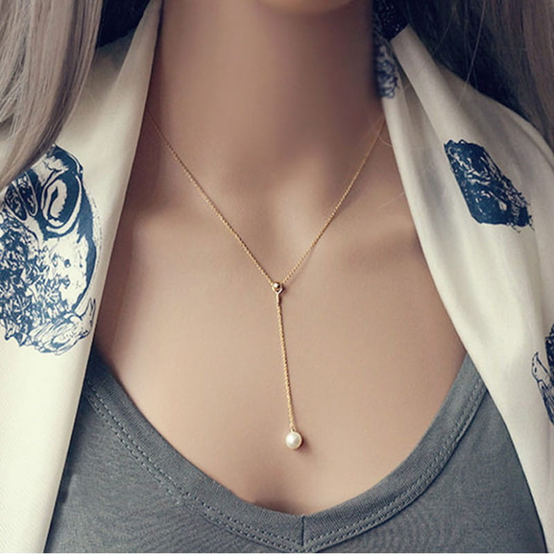 Gold-toned adjustable lariat necklace featuring a single pearl pendant in rose gold and silver.