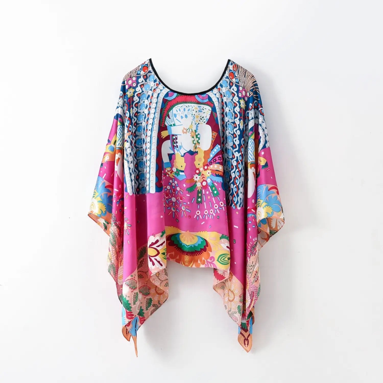 A vibrant pink and blue printed silk patterned pullover shawl cape outerwear featuring a bold central elephant illustration adorned with floral motifs.