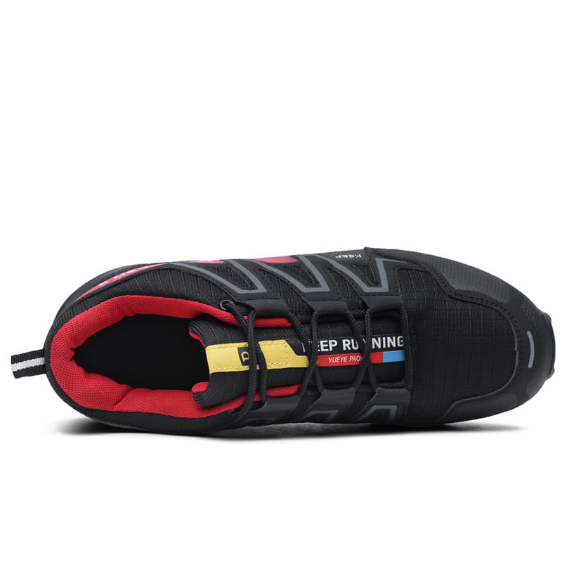 Men’s trail running shoes with breathable black mesh upper and reinforced rubber outsole featuring red and yellow accents.