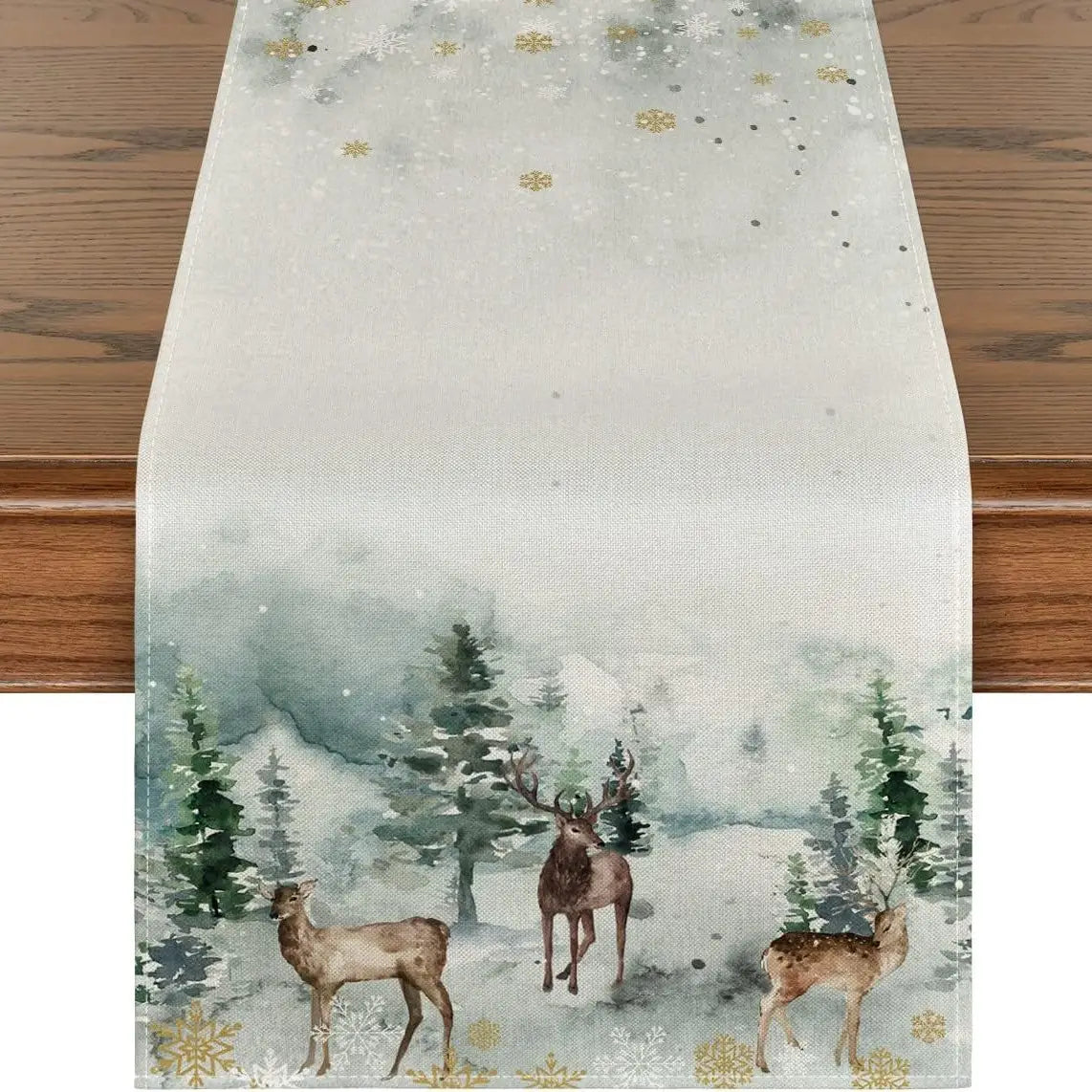 a festive winter-themed christmas table runner featuring a watercolor design of deer and pine trees on a light gray background accented with gold snowflakes measuring 183 by 33 inches