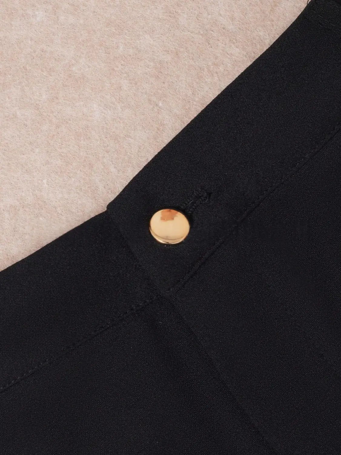 A sleek black fabric high waist straight leg trousers plus size garment featuring a single round gold toned button at the neckline.