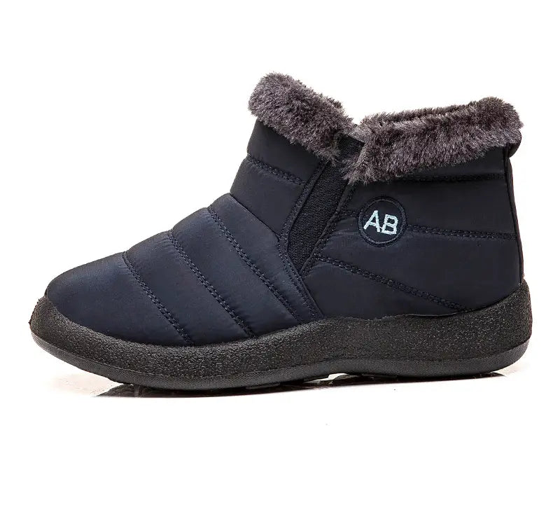 Botte d’hiver imperméable en neige bleu marine foncé, avec panneaux matelassés et doublure intérieure moelleuse en fausse fourrure grise pour une chaleur de cheville isolante.