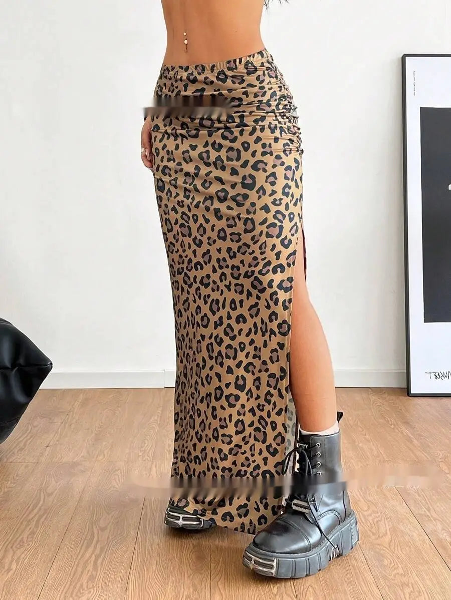 A high-waisted full-length leopard print maxi skirt with a side slit and ruched waistband made from lightweight fabric.