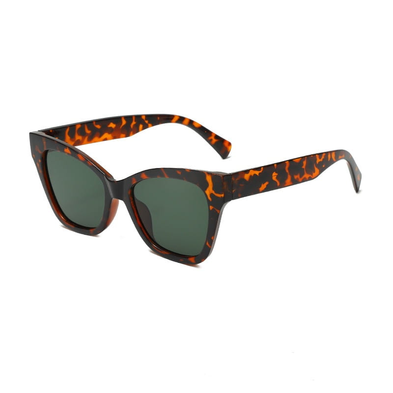 Gafas de sol de moda retro con forma de ojo de gato con monturas carey y lentes verde oscuro que ofrecen protección UV.