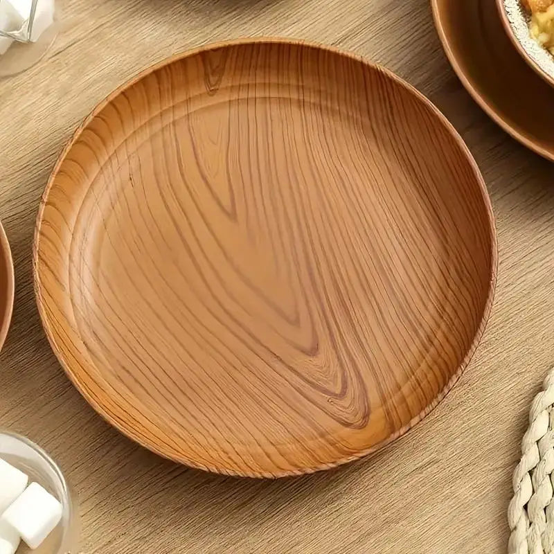Round wooden plastic plate with warm natural finish and visible wood grain patterns in a 10 piece wood grain plastic plates set with striped design