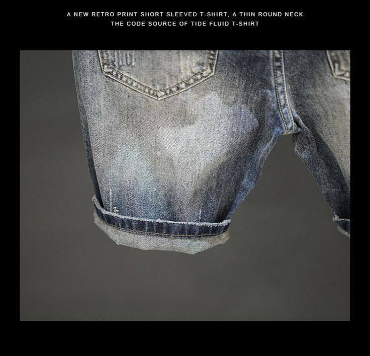 Distressed maple leaf denim shorts featuring washed denim material with a faded blue wash and rolled cuffs.