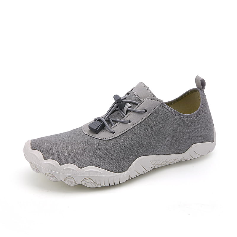 Gray canvas breathable non slip mesh slip-on shoe with white rubber sole and black laces designed for beach and trekking use.