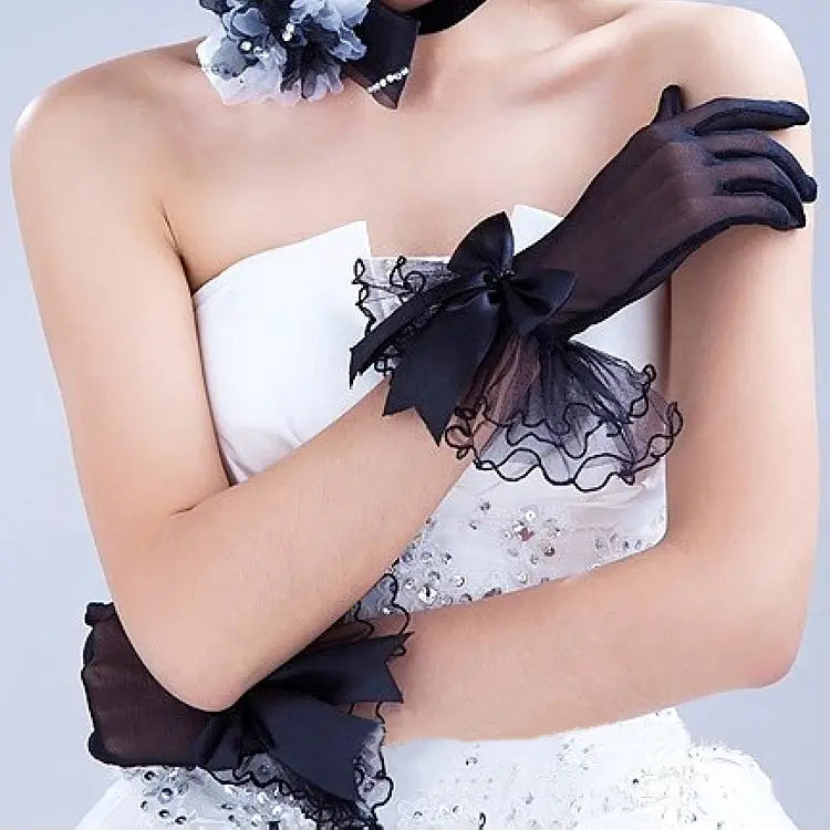 elegant black lace and satin bow evening gloves featuring sheer fabric with ruffled edges and satin bows.