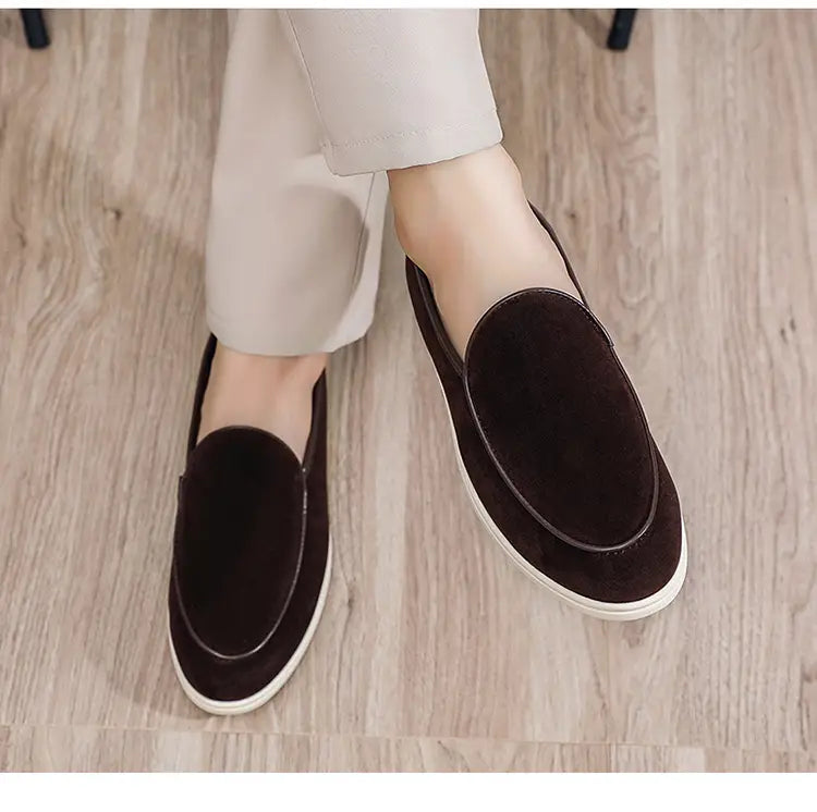 Dark brown suede men’s slip on loafers featuring a white rubber sole for casual and formal wear.