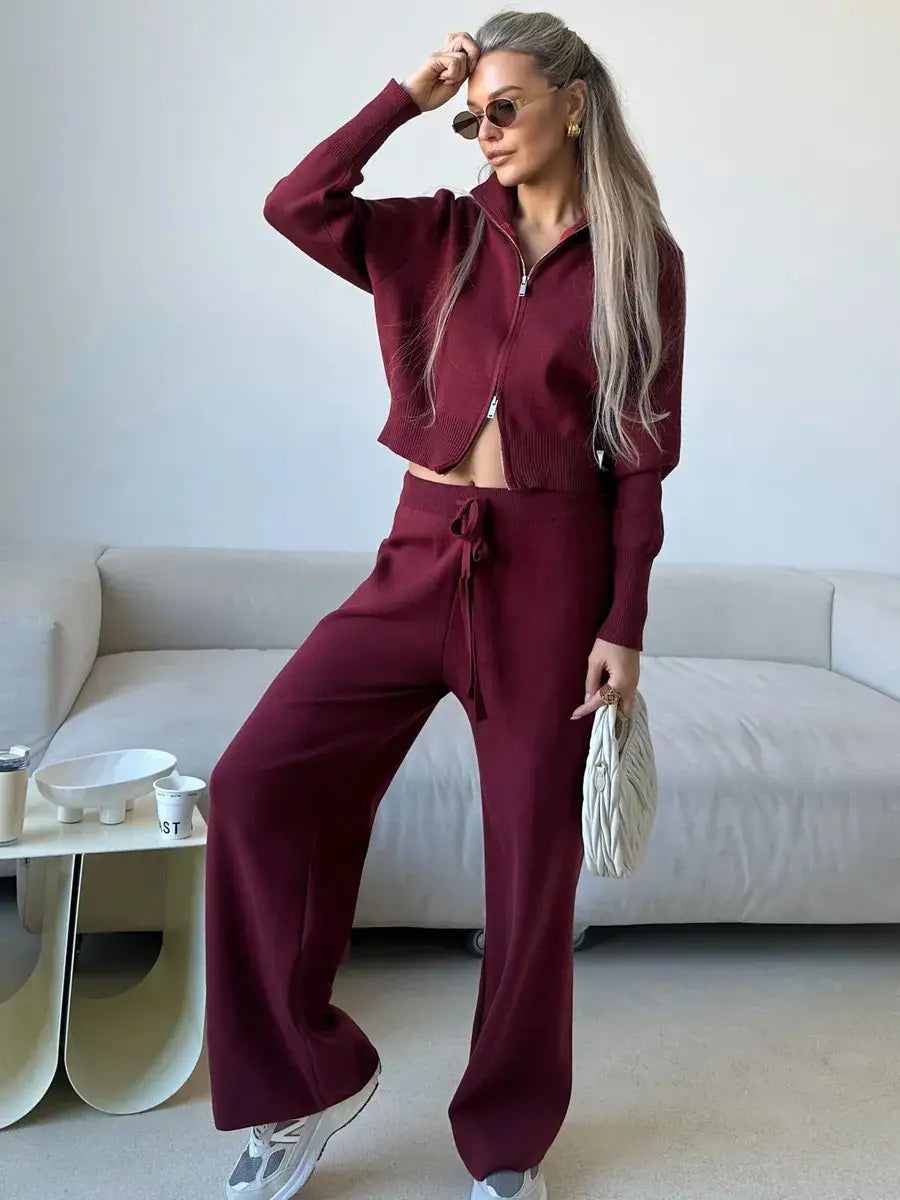 Women’s knit zip up cardigan and wide leg pant set in maroon featuring a cropped zip-up top and wide-leg pants made from knit material.