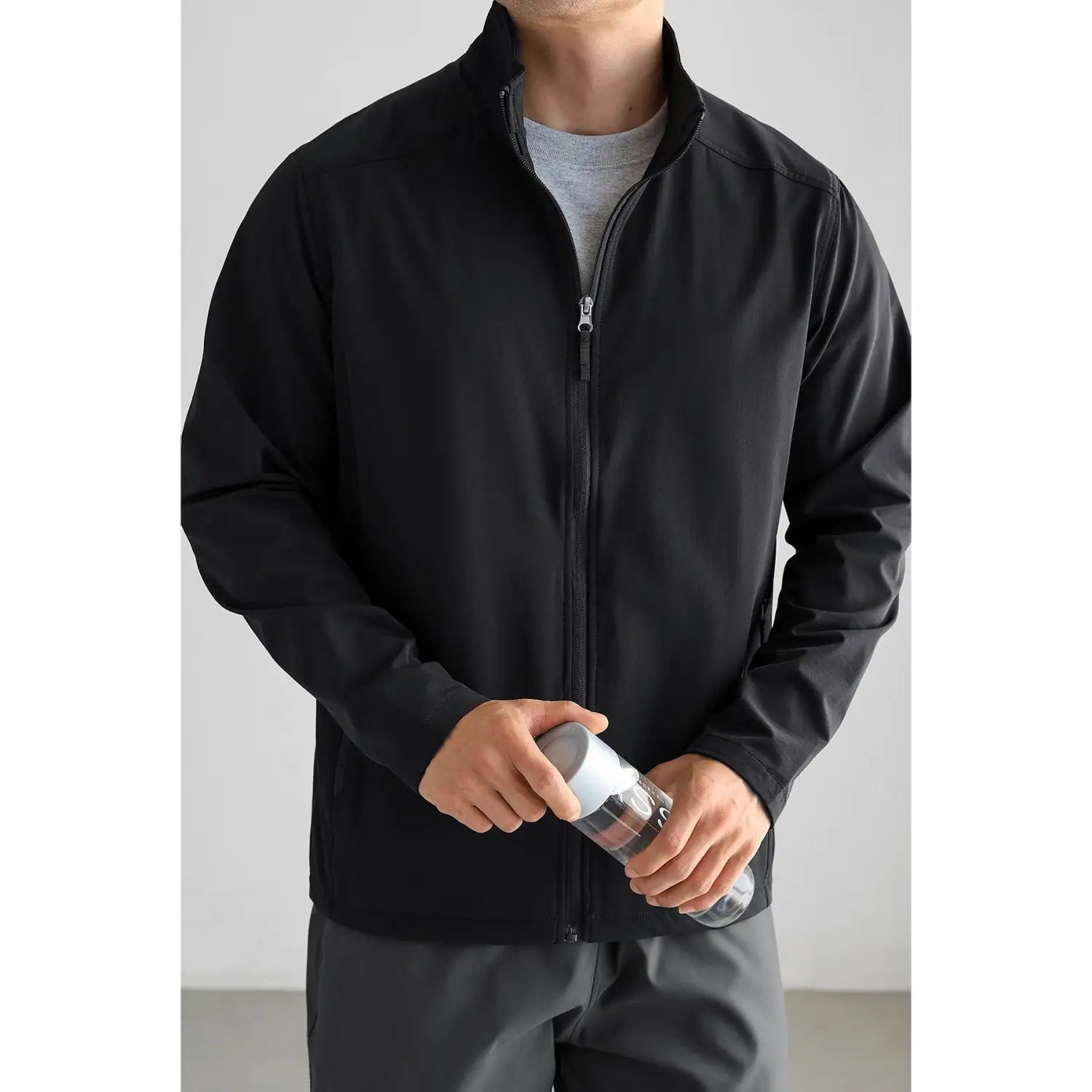 Veste bomber noire pour homme, avec un design zippé épuré et des détails de surpiqûres subtils pour les trajets quotidiens décontractés