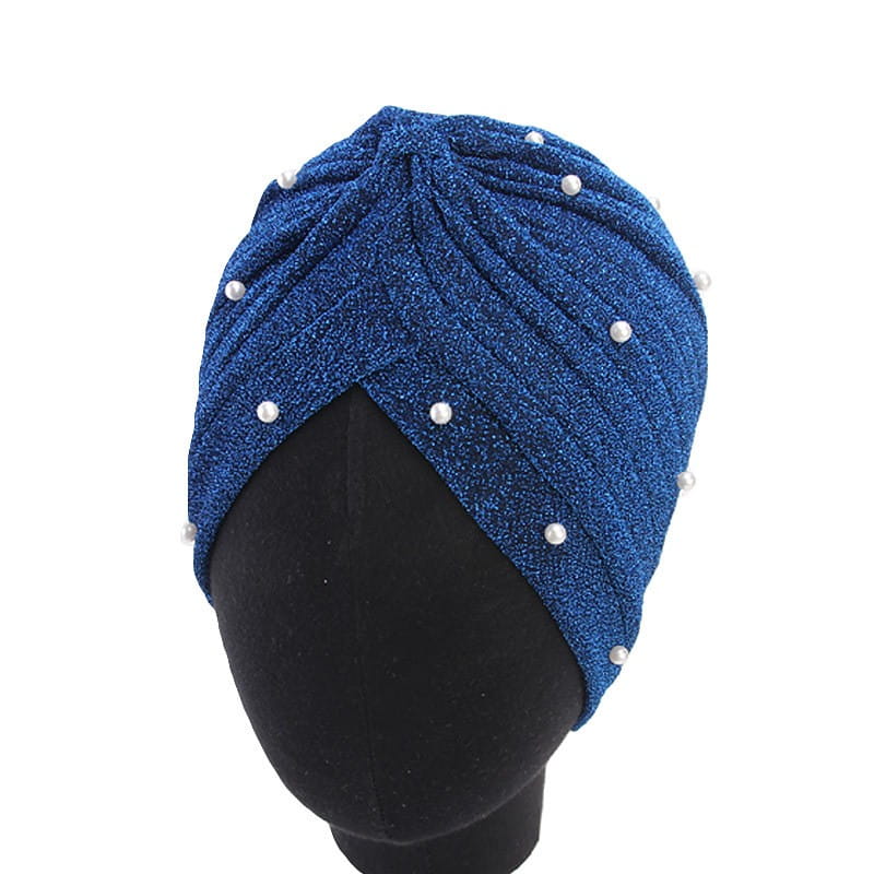 A shimmering royal blue pearl turban headscarf cap for women made of jacquard fabric and adorned with evenly spaced white pearls.