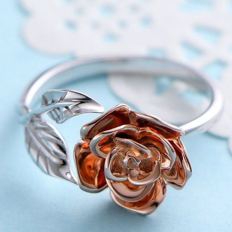 Two tone rose and leaf adjustable silver ring featuring a delicate copper-toned flower and silver leaves crafted in metallic alloy.