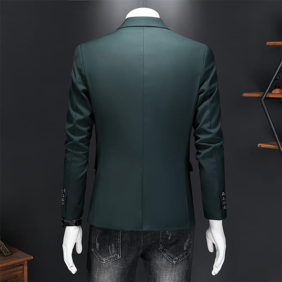 Chaqueta de vestir empresarial de pana verde oscuro con ajuste slim, corte a medida y brillo sutil, con puños abotonados.