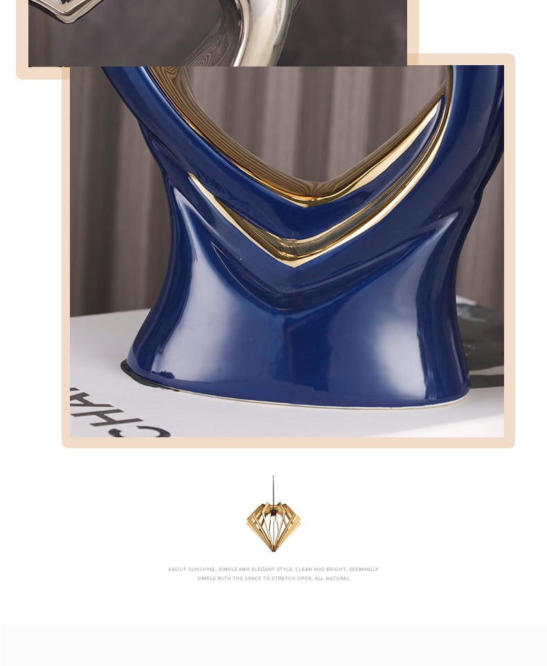 A glossy navy blue ceramic abstract heart figurine with sleek modern design and gold-trimmed curves for home decor.