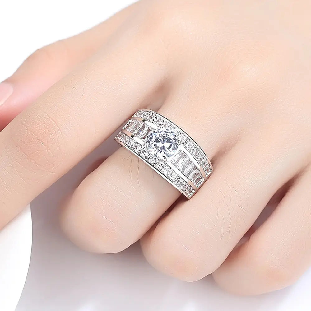 A vintage zircon heart arrow adjustable silver ring featuring a sleek silver band with a central round-cut diamond flanked by baguette diamonds and smaller accent stones.