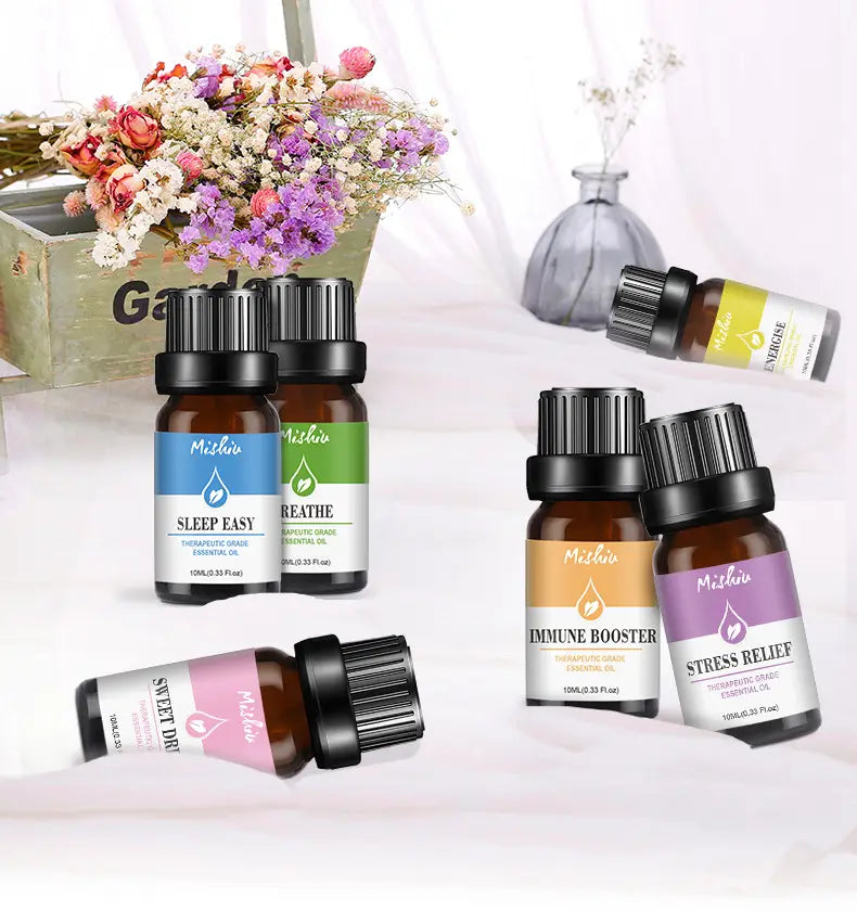 Set of five brown glass bottles with black caps and colorful labels each containing different therapeutic grade essential oils from mishi pure aromatherapy essential oil 10ml.