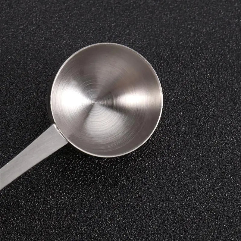 A sleek 304 stainless steel measuring spoon kitchen tool featuring a brushed stainless steel handle and polished reflective bowl.
