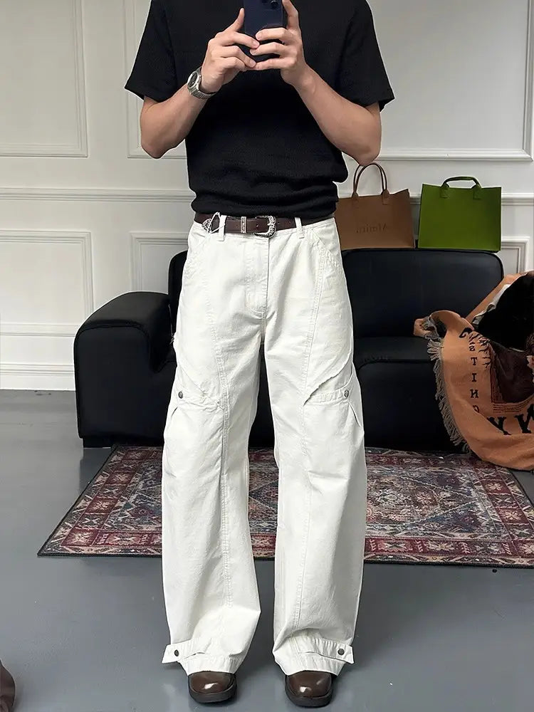 white wide-leg cargo pants featuring multiple pockets and buttoned cuffs made of durable fabric for practical use.